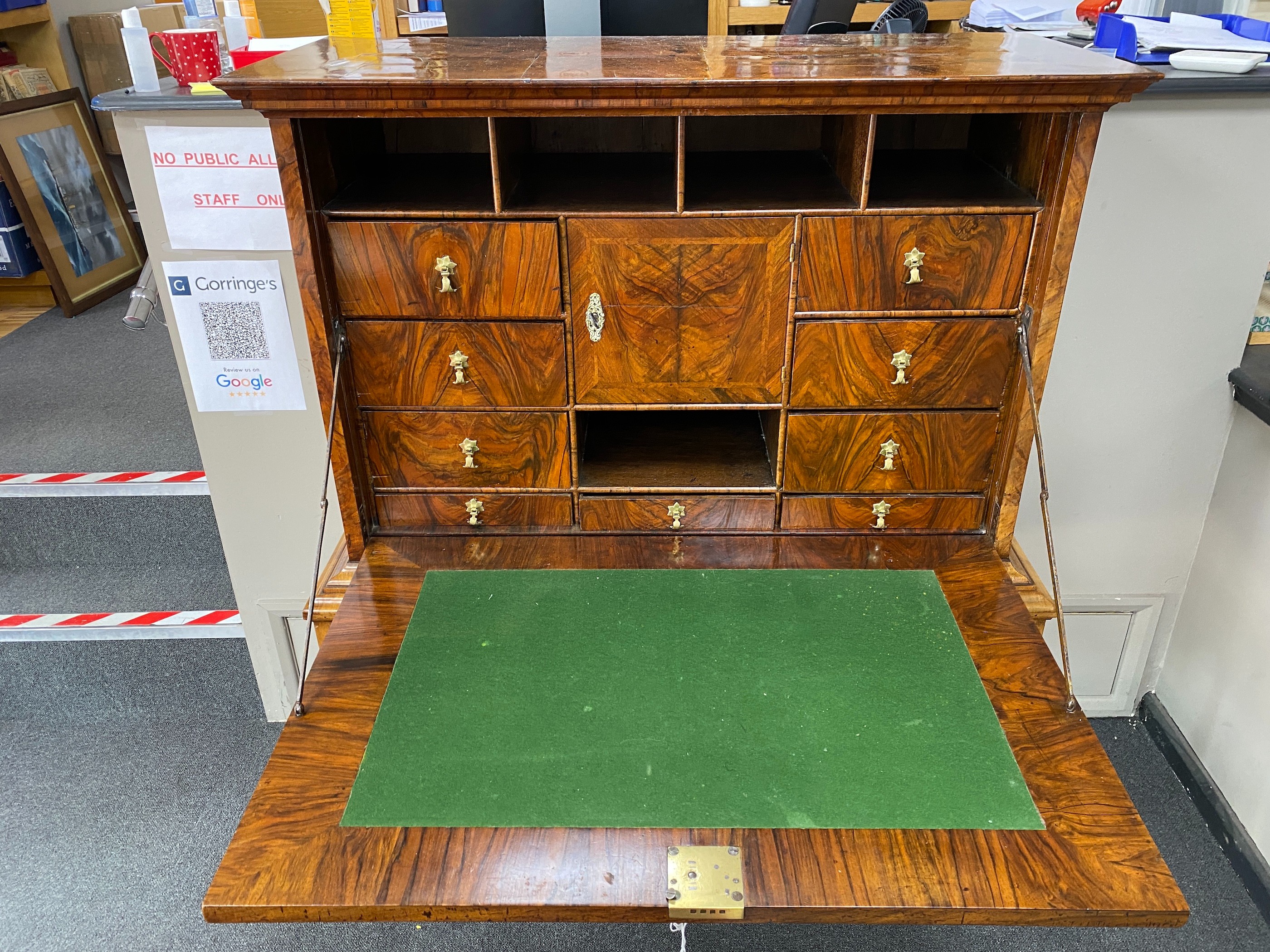 An early 18th century banded walnut fall front secretaire, the interior fitted with numerous drawers, raised on a later stand, width 110cm, depth 49cm, height 147cm